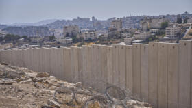 The separation wall next to the Arab neighbourhood of Al-Eizariya, near where the Israeli government says housing units will be built as part of the its 'E1' settler project, pictured on August 1