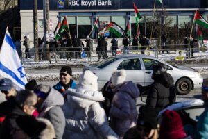 Pro-Palestinian protestors gather across from a Hanukkah event on the corner of Bathurst and Shepard.