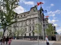 People walk by Montreal City Hall on July 14, 2019 in Montreal, Quebec. Photo by Daniel Slim/AFP via Getty Images.
