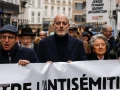 Joël Rubinfeld, president of the Belgian League Against Antisemitism, center, and Regine Sluszny, president of the Forum of Jewish Organizations of Belgium’s Flemish Region, carry a banner as they take part in a march against Antisemitism in Brussels, Belgium on Dec. 10, 2023. Photo by SIMON WOHLFAHRT/AFP via Getty Images.