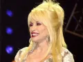 Music legend Dolly Parton on stage at the Grand Ole Opry during a live broadcast in Nashville, Tenn., on April 23, 2005. Credit: U.S. Department of Defense photo by Tech. Sgt. Cherie A. Thurlby, U.S. Air Force/Public Domain via Wikimedia Commons.