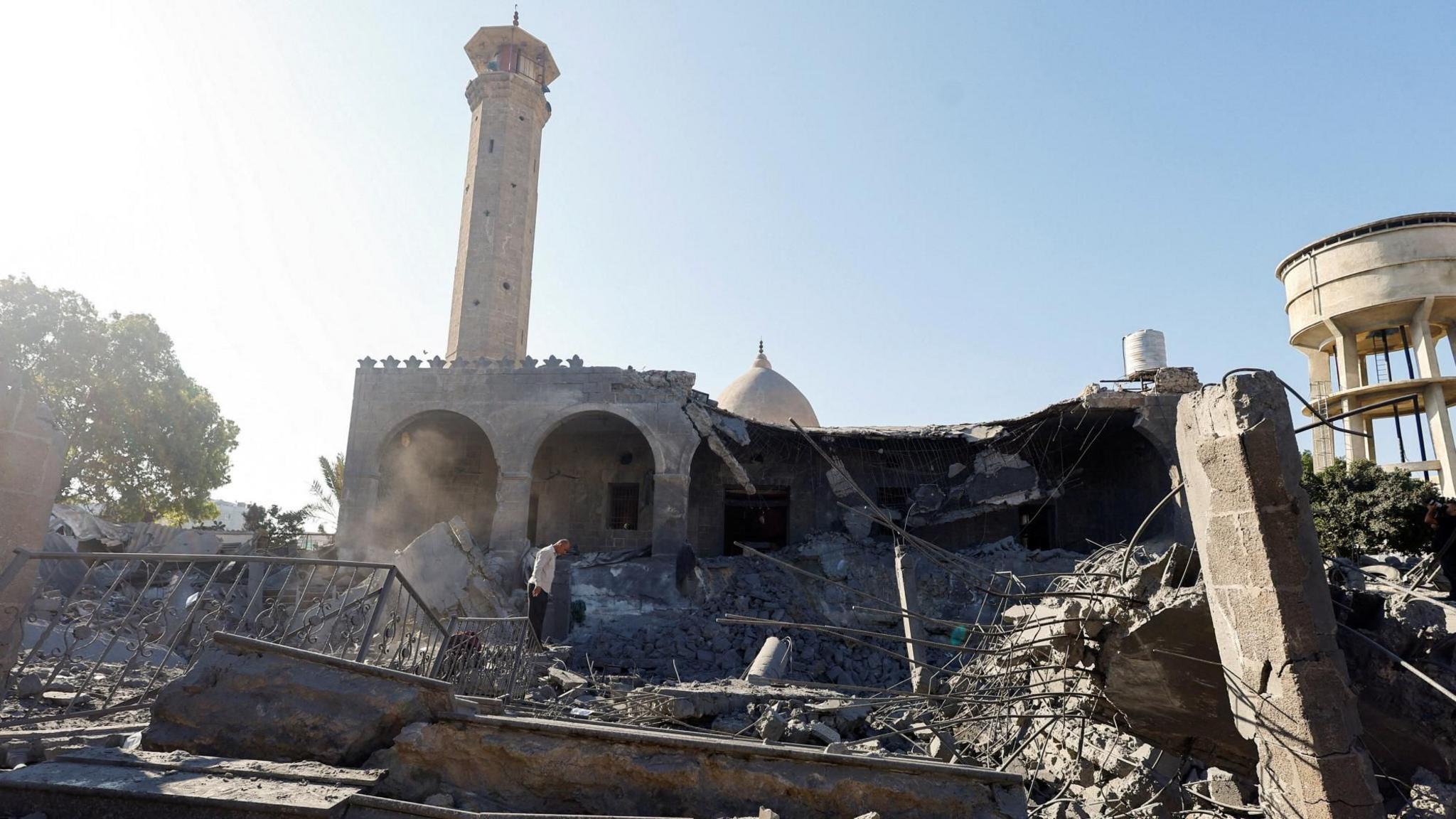 A Palestinian man inspects a mosque damaged in an Israeli strike, in Deir al-Balah, central Gaza (25 August 2026)