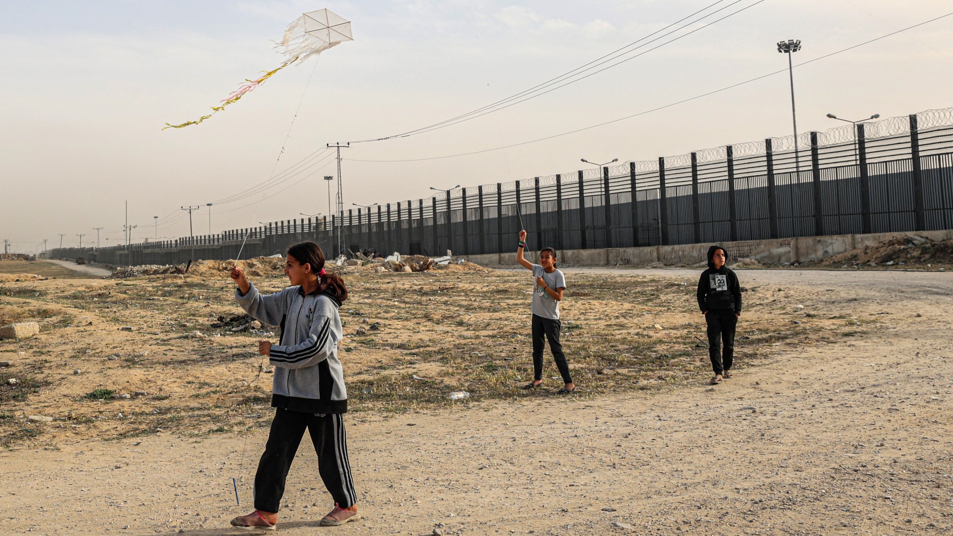 Displaced Palestinian children fly kites near the border with Egypt in Rafah in the southern Gaza Strip on March 28, 2024, amid the ongoing conflict between Israel and Hamas militants. SAID KHATIB / AFP