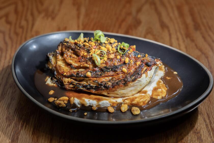 LOS ANGELES, CA - JULY 23, 2026: Fire-roasted cabbage with harissa miso glaze, cultured tahini labneh crema and peanut crunch at Alta Adams in Los Angeles, CA on Thursday, July 23, 2026. (Myung J. Chun / Los Angeles Times)]