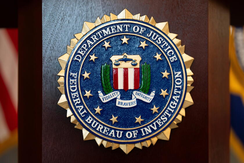 FILE - An FBI seal is displayed on a podium before a news conference at the field office in Portland, Ore., Jan. 16, 2025. (AP Photo/Jenny Kane, File)