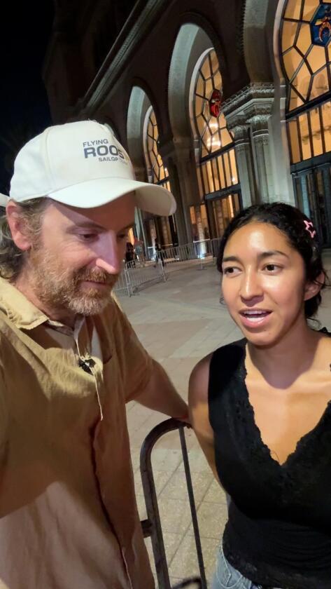 A man and woman outside of the Shrine Auditorium.