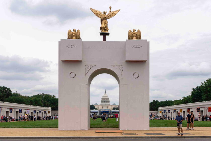 FILE - A mockup of President Donald Trump's proposed triumphal arch stands at the Great American State Fair on the National Mall, June 27, 2026, in Washington. (AP Photo/Jen Golbeck, File)