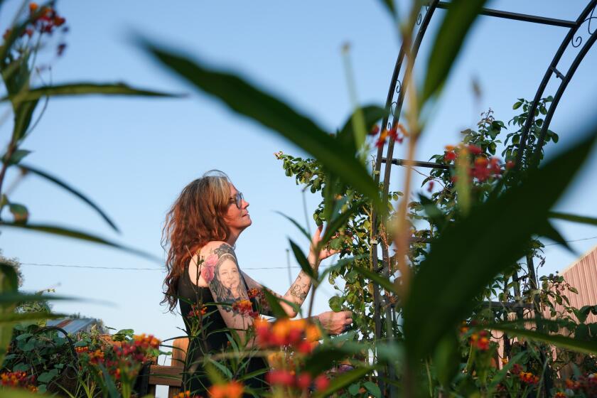 PRINCETON, KS AUGUST 24, 2026 DD Jessica Leffler looks at the flowers in RubyOs memorial garden. Jessica Leffler's daughter Ruby Davis-Leffler, died from suicide in 2024, at the age of 15. Ruby had been diagnosed with autism the year before, something that her mom wishes had been identified sooner. (Arin Yoon / For The Times)