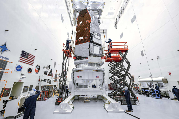 Technicians and engineers at NASA’s Kennedy Space Center in Florida use a crane to lift the agency’s Nancy Grace Roman Space Telescope to a specialized work stand Friday, June 26, 2026. 