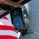 An American flag flies behind a Flock Safety camera tmounted to a light pole