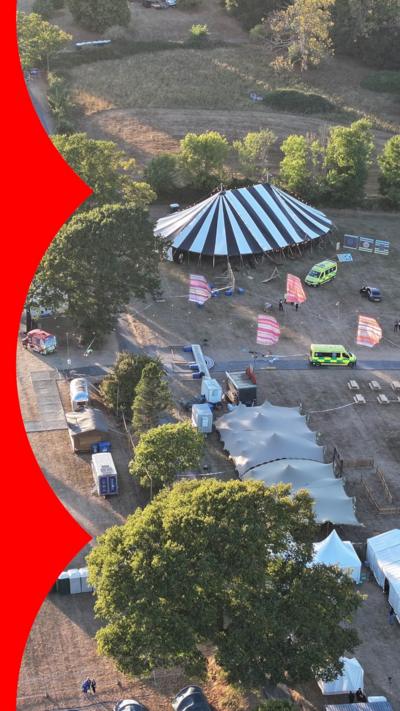 Aerial photo showing festival tents and ambulances at the scene