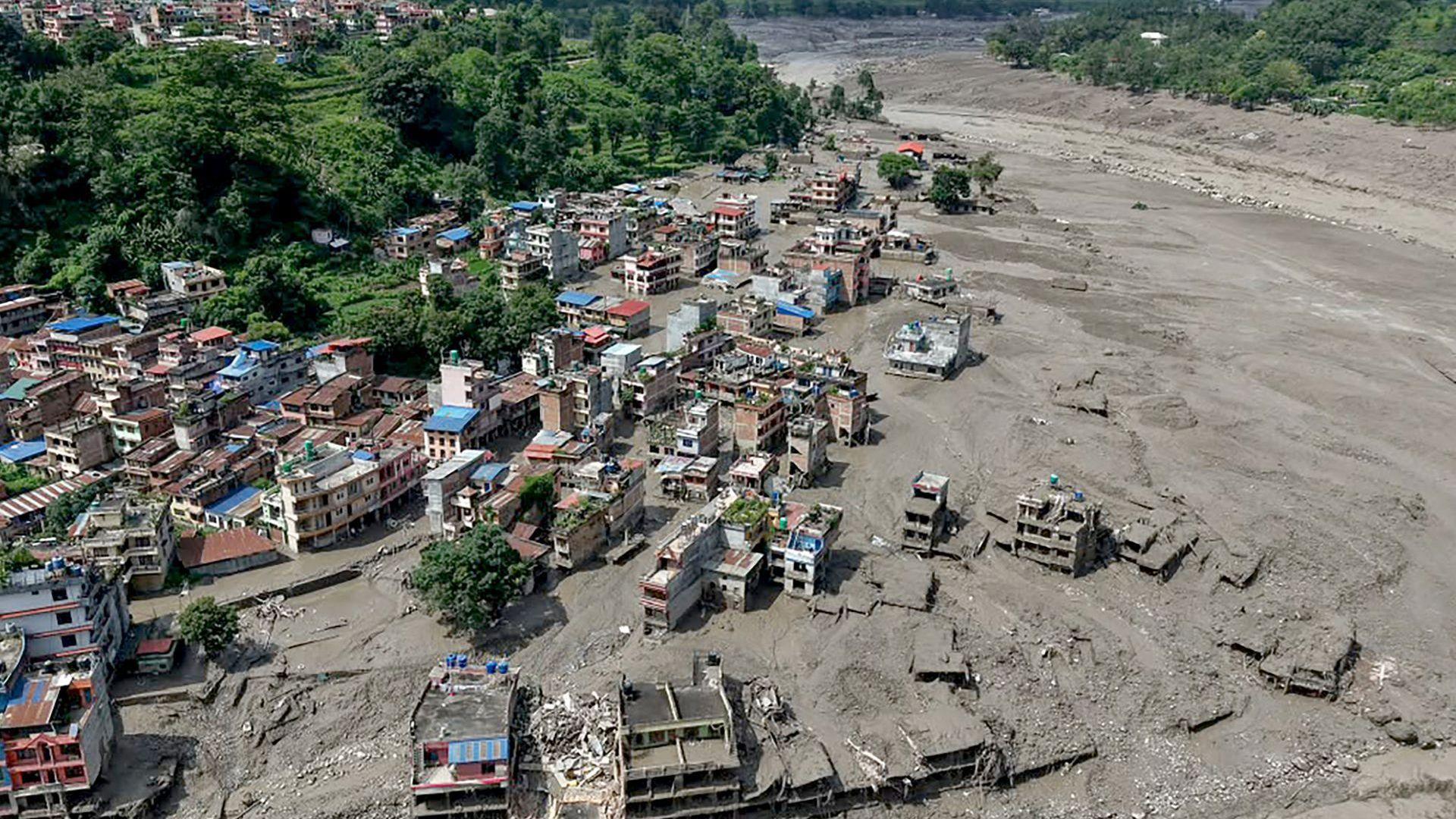 An aerial view of the flooded riverside with houses and buildings partially submerged at Trishuli Bazar in Nepal's Nuwakot district