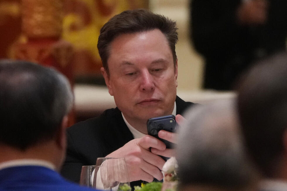 Elon Musk uses his phone during a state dinner for US President Donald Trump and Chinese President Xi Jinping at the Great Hall of the People
