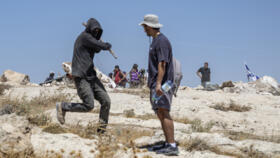 An Israeli settler attacks a left-wing activist at an Israeli outpost in the Israeli-occupied Palestinian village of Jannatah, just south of the city of Bethlehem on August 25, 2026