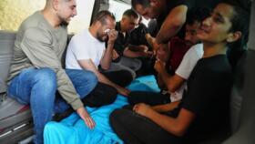 Relatives of Palestinian teenager Karim Shalaldeh, 17, cry over his body at a hospital in the West Bank city of Hebron, Friday, August 21, 2026