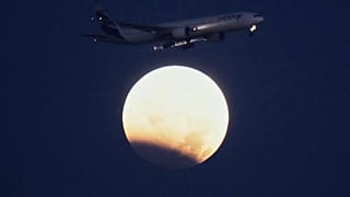 Near-total lunar eclipse as moon passes through Earth's shadow
