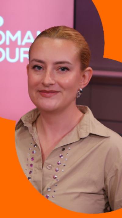 A woman with blonde hair smiles at the camera