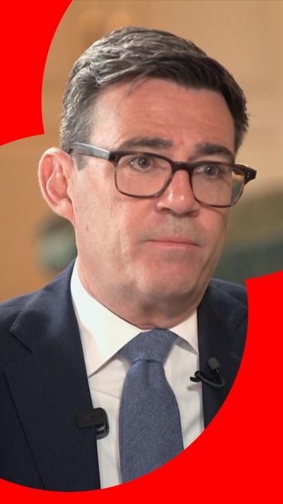 Close-up of Andy Burnham wearing navy suit during sit-down interview