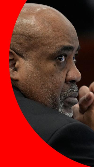  A profile shot of Duane "Keffe D" Davis. He is bald. He has a white goatee. He is wearing a black suit jacket.