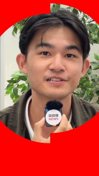 BBC Journalist Osmond Chia looks into the camera. He has black hair and is wearing a black jacket over a white T-shirt.