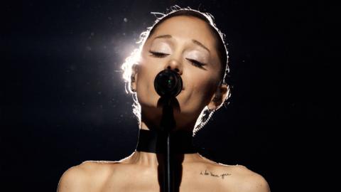 Ariana Grande singing into a microphone