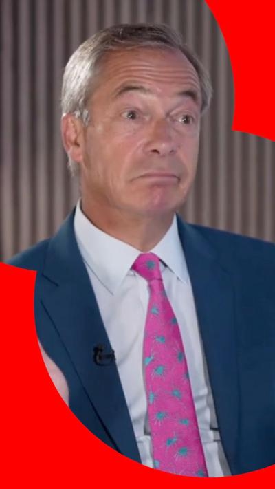  A man in a patterned pink tie, white shirt and blue suit.