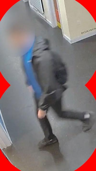 CCTV of a school student walking. His face is blurred.