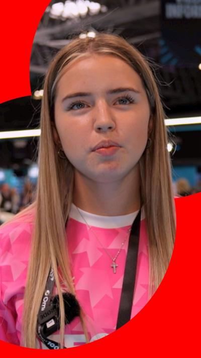 A woman in a pink sport shirt and long blonde hair