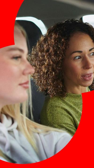 A learner driver and her instructor in a car