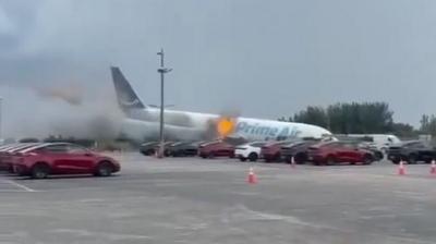 Prime Air plane nose down after crashing at Miami airport.