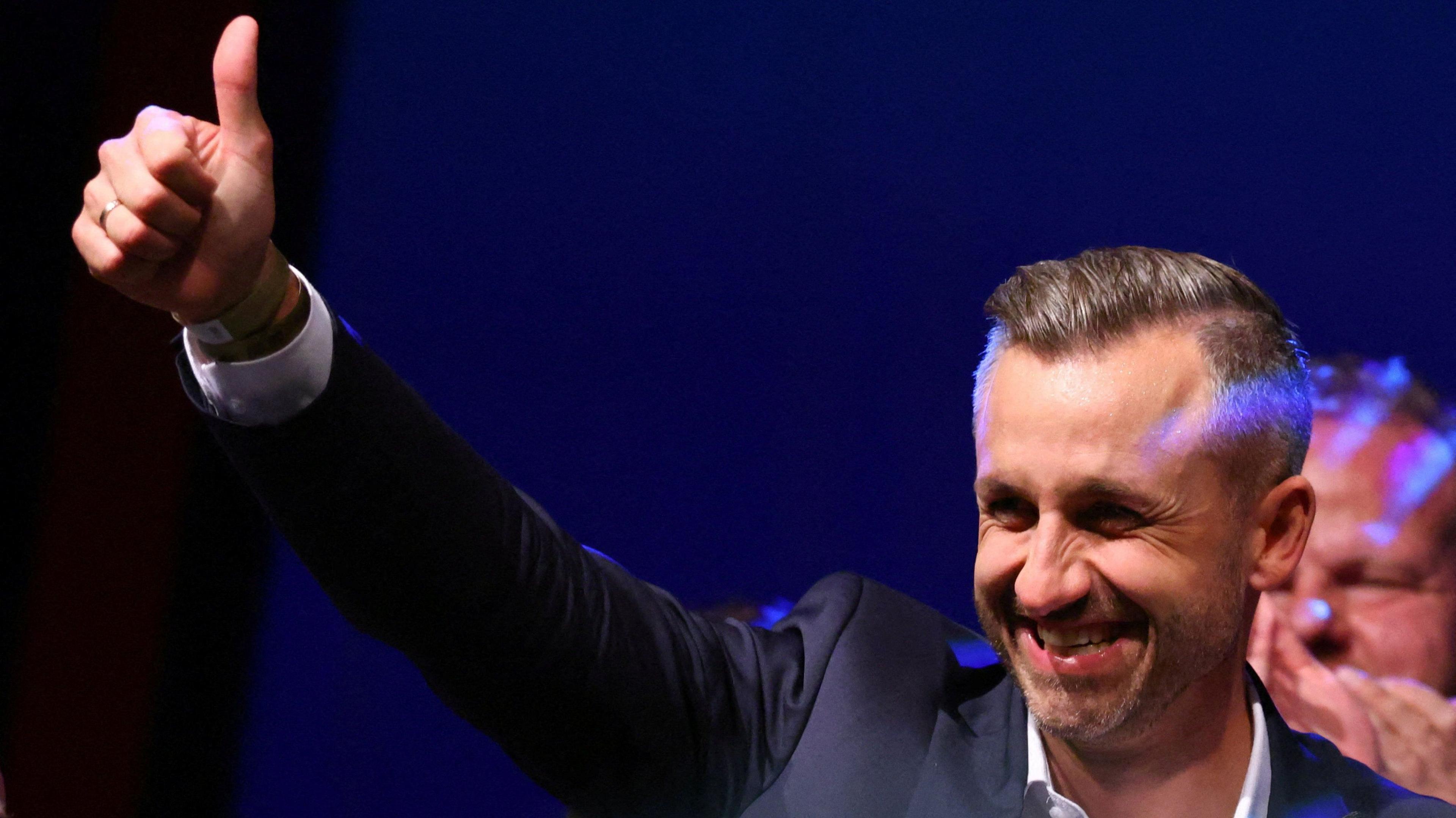 Ulrich Siegmund, leader of the AfD in the state, raises a thumbs up at the election party.