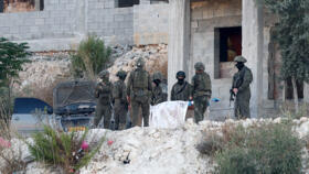 Israeli military forces carry the body of a Palestinian, following an Israeli military airstrike, in Jenin, in the Israeli-occupied West Bank, August 28, 2026. 