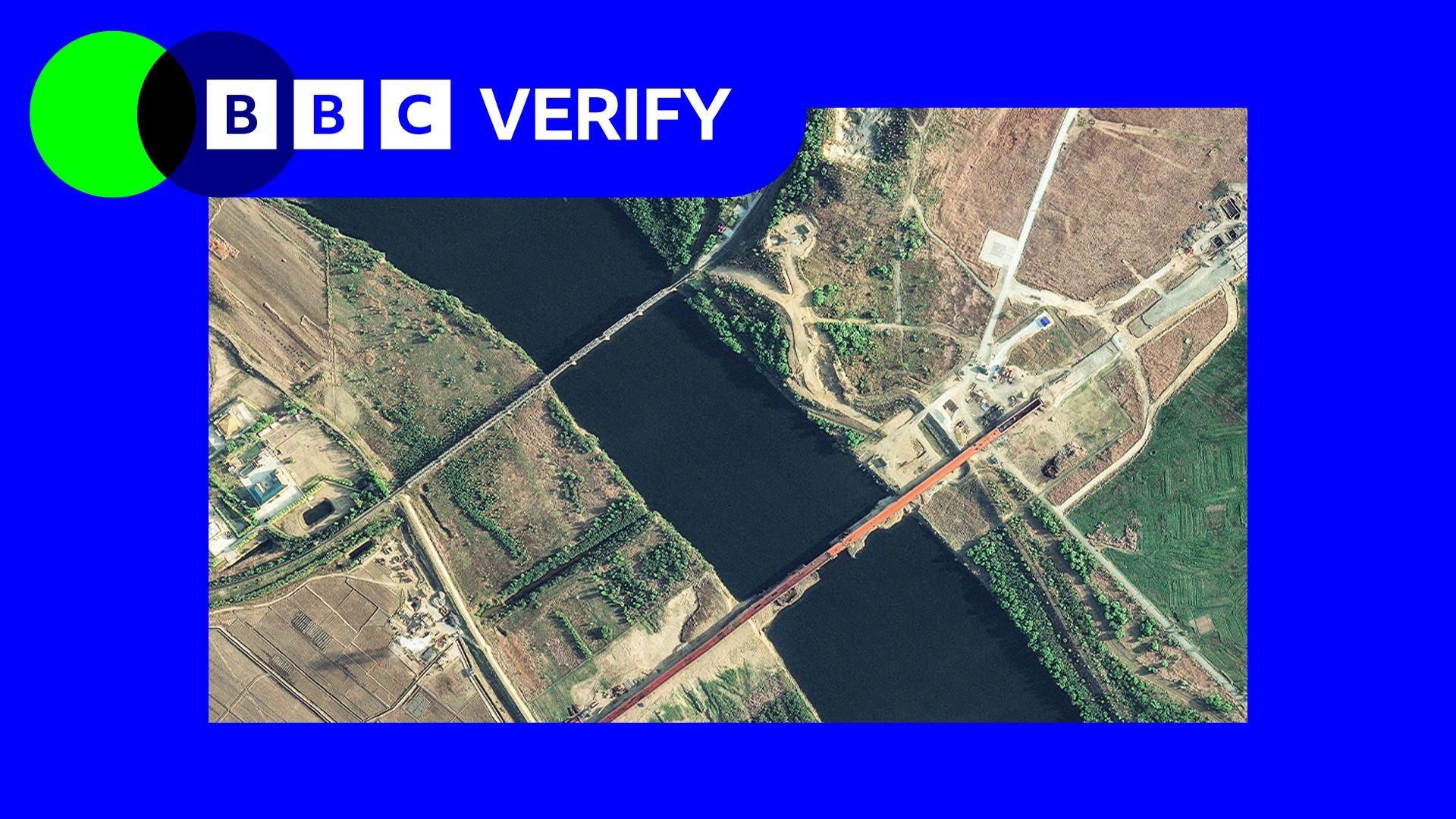 An annotated satellite image taken on 6 May showing the new road bridge and the existing rail bridge. It is imposed over the BBC Verify colours and branding. 