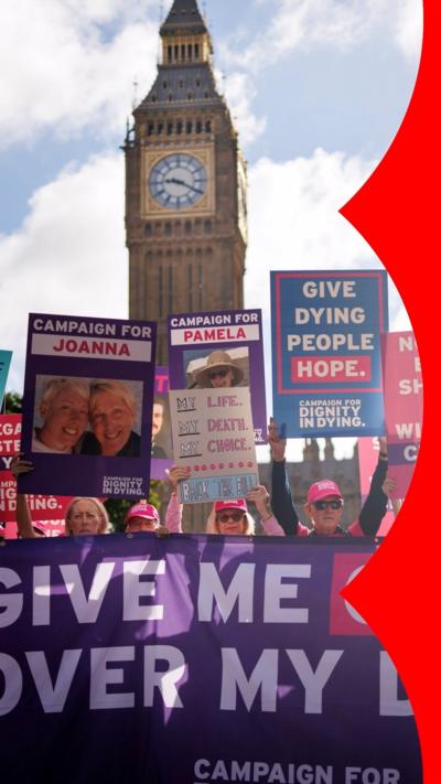 Pro-assisted dying campaigners hold pink placards during a protest near Big Ben