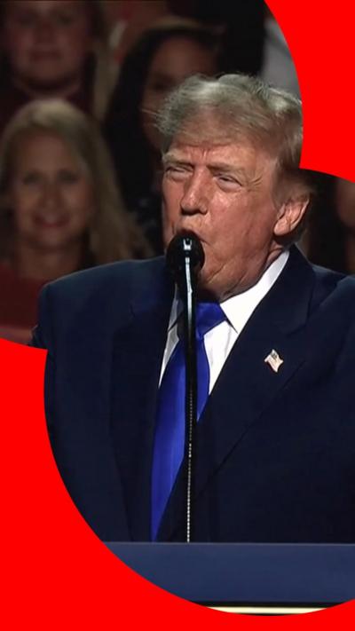 Trump speaks at a podium