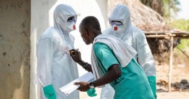 Members of a decontamination team wearing safety suits during the West Africa Ebola epidemic in 2015. The World Health Organization has declared the latest Ebola outbreak in the Democratic Republic of Congo a public health emergency of international concern. Photo Credit: Corporal Paul Shaw/MOD (CC BY 2.0)
