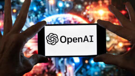 The OpenAI logo is displayed on a cell phone