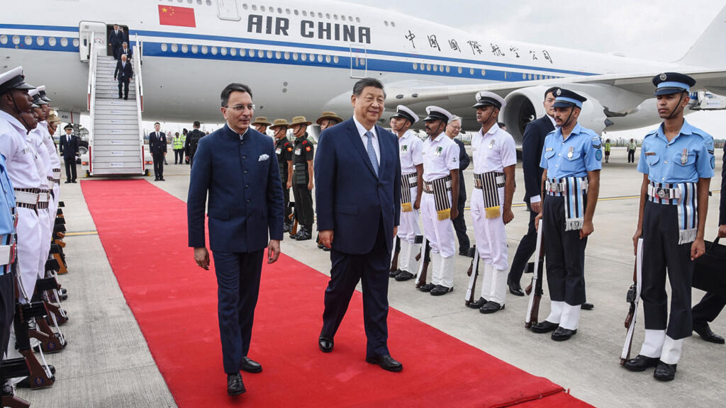 Chinese President Xi Jinping (C) walking upon his arrival in New Delhi on September 12, 2026