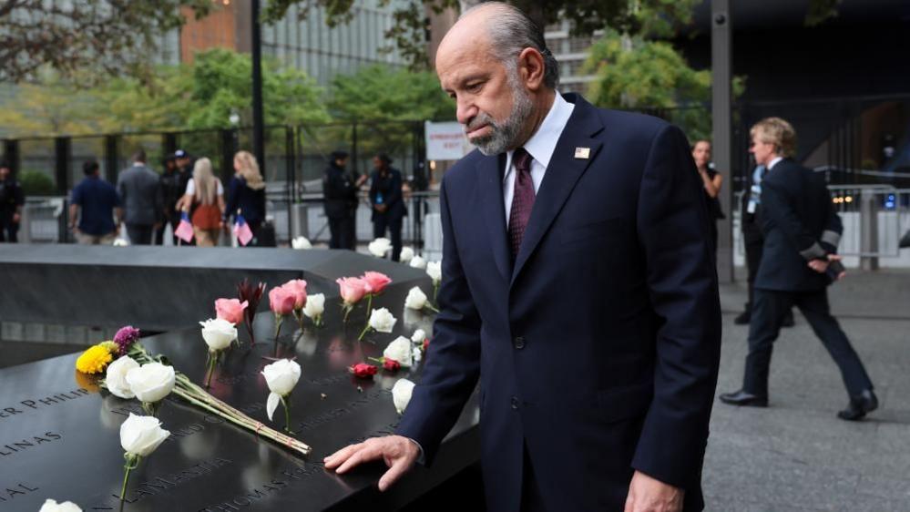 U.S. Commerce Secretary Howard Lutnick pauses at the memorial ahead of a ceremony commemorating the 25th anniversary of the September 11th attacks on the World Trade Center at the National 9/11 Memorial & Museum in New York.
