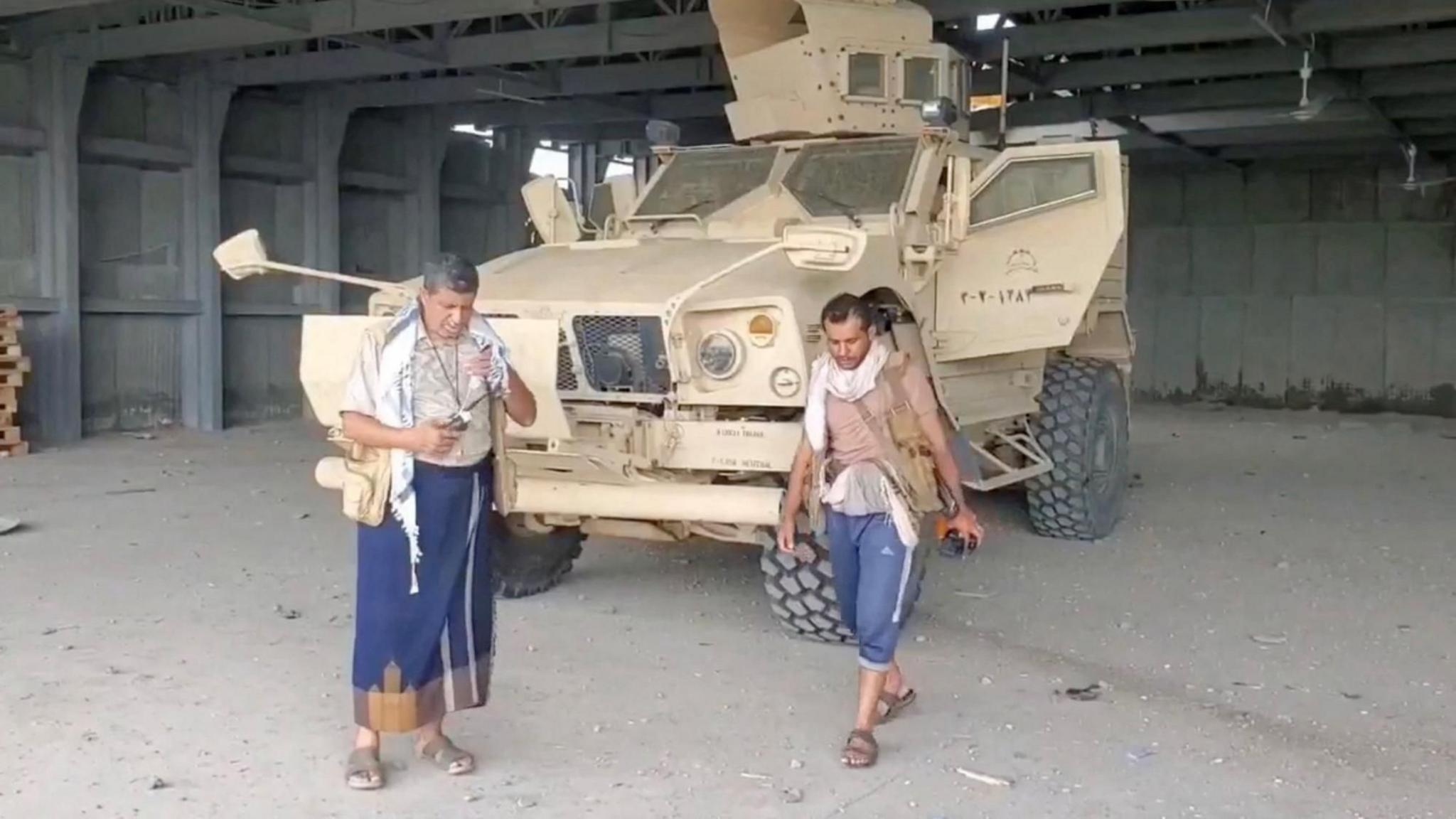 Screengrab of a video from Houthi-run Al Masirah TV showing an armed man walks next to an armoured vehicle in Mokha, Yemen, after the Houthis seized the Red Sea port city (10 September 2026)