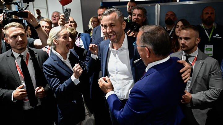 Ulrich Siegmund, top candidate in the Saxony-Anhalt state election for the far-right Alternative for Germany (AfD) party AfD's main candidate in the Saxony-Anhalt state election Ulrich Siegmund (C), co-leaders of the far-right Alternative for Germany (AfD) party Alice Weidel and Tino Chrupalla celebrate after exit polls following Saxony-Anhalt's state elections at the fairgrounds in Magdeburg, eastern Germany on September 6, 2026. 