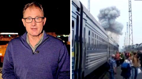 Split screen showing BBC reporter talking to camera at night and a train with smoke from an explosion above it.