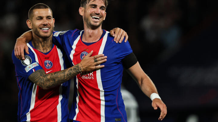 PSG's Spanish midfielder #08 Fabian Ruiz (R) celebrates with Paris Saint-Germain's French defender #21 Lucas Hernandez after scoring his team sixth goal during the UEFA Champions Leagu