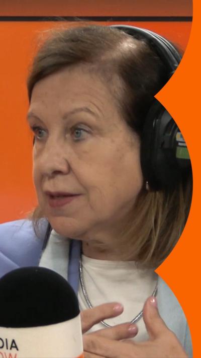 Journalist Lyse Doucet sits in front of microphone. She has brown, chin-length hair.