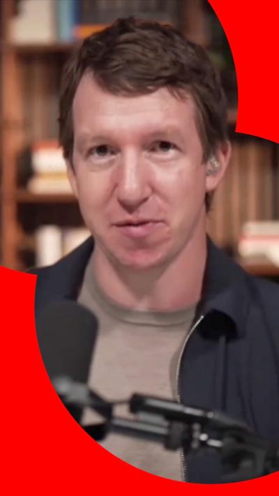 Jack Clark, a man with short brown hair, dressed in a blue coat