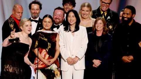 Cast and crew including Colton Dunn, presenter Woody Harrelson, Katie Dippold, Matthew Rhys, Carver Karaszewski, Neil Casey, Kingston Rumi Southwick, Jeff Hiller and Kevin Carroll, accept the Outstanding Comedy Series Award for "Widow's Bay" on stage during the 78th Primetime Emmy Awards held at the Peacock Theater on September 14, 2026. 