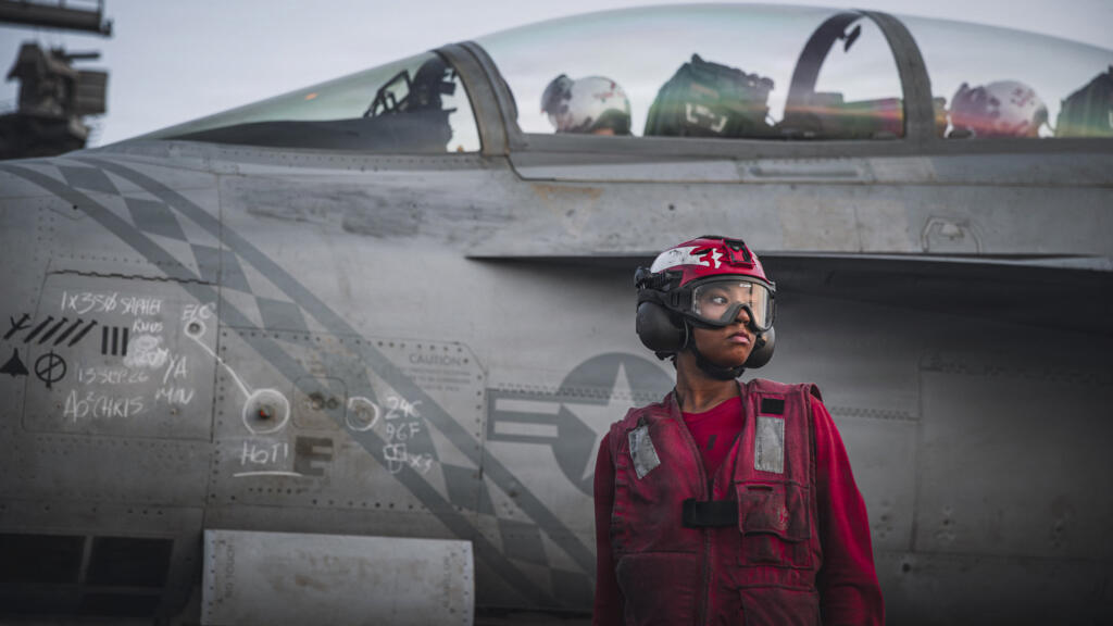 This handout picture released by the US Navy on September 13, 2026, shows a sailor after checking ordnance on an F/A-18 Super Hornet on the flight deck of aircraft carrier USS George Washington.