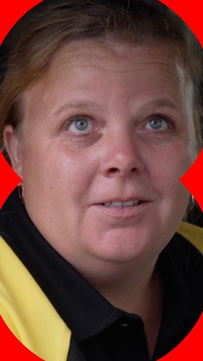 A woman with blonde hair pulled back from her face looks off-camera