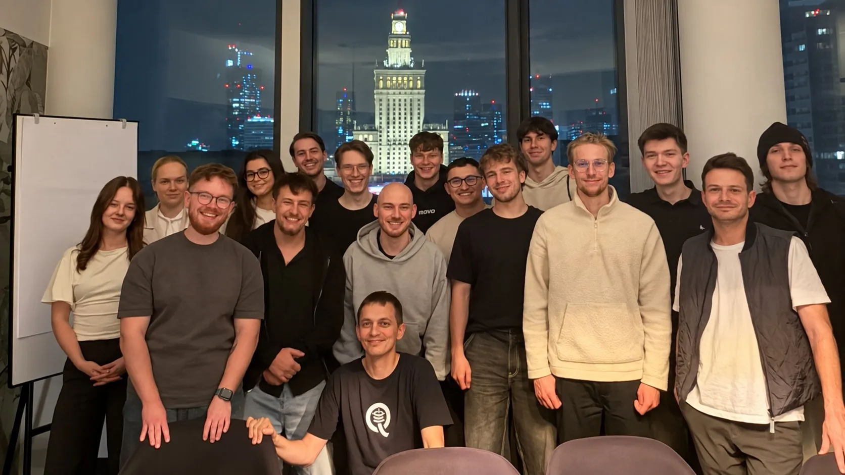 Participants and organizers at Quesma’s first token economics hackathon, with Warsaw behind us. We used AI to remove the lamps from this photo.