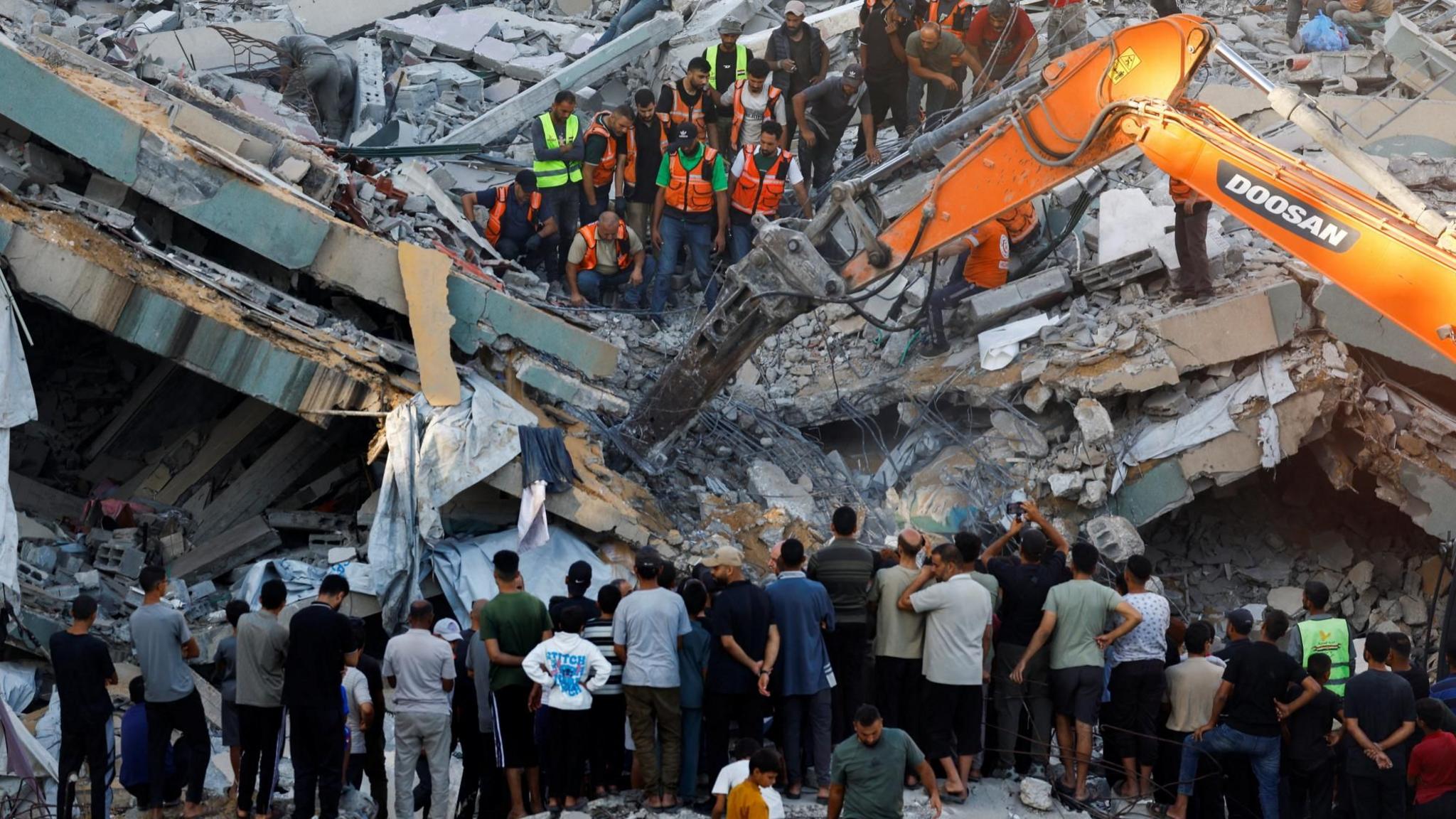 Gaza Civil Defence first responders attempt to rescue people trapped beneath the rubble of a war-damaged residential building that collapsed in Gaza City (16 September 2026)